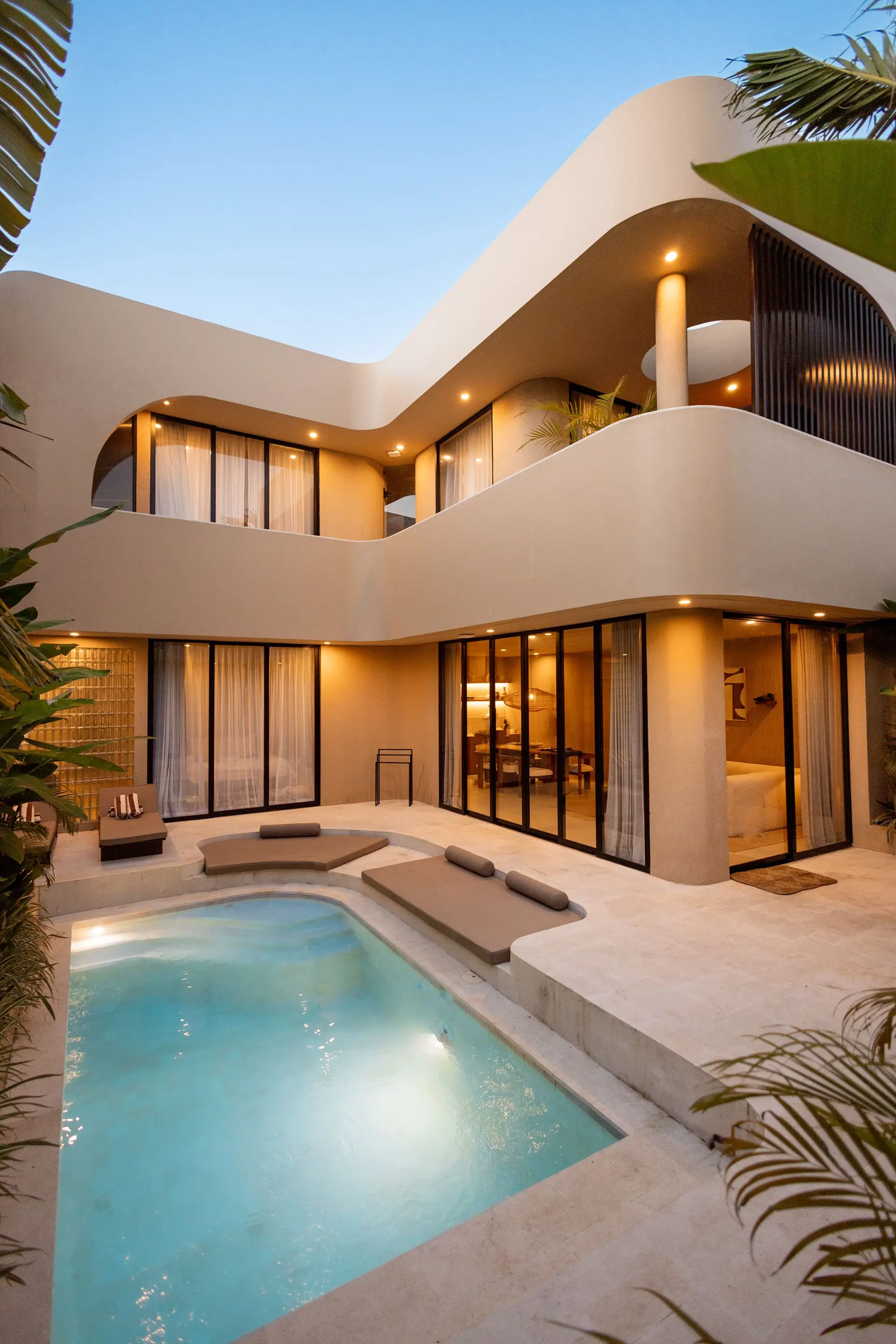 SISI Wellness Villa at dusk with pool and palm trees in Bingin, Bali